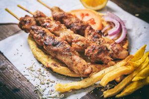Meat skewers on a wooden background